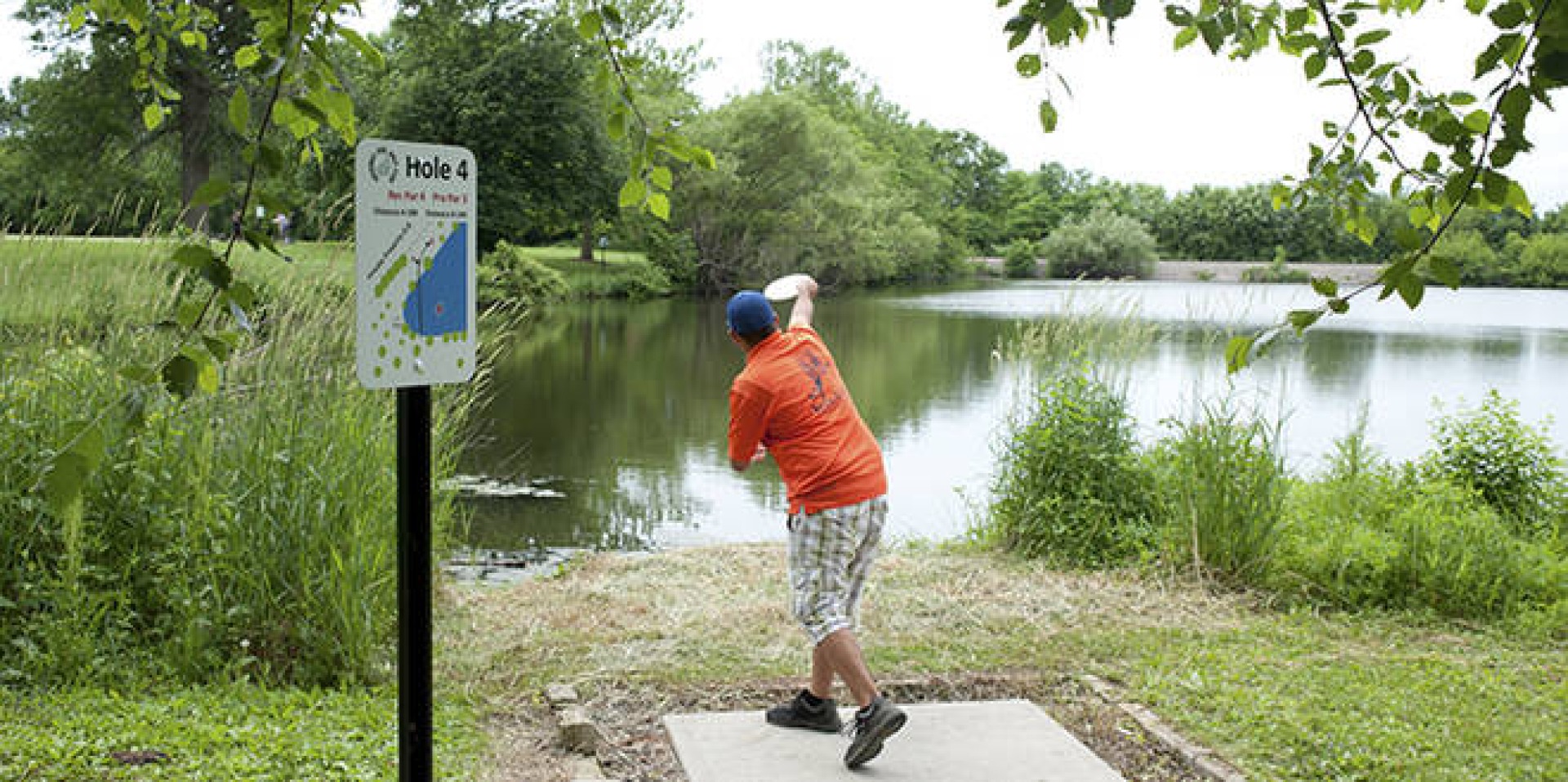 A disc golfer throws his disc from hole 4 at Lake Nyanza.